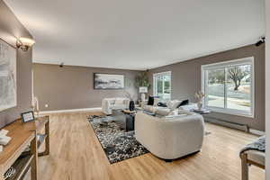 Living area featuring light wood-style floors and baseboard heating