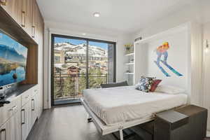 Bedroom with a mountain view and access to exterior