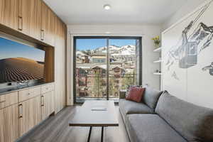 Living area with a mountain view and dark wood-type flooring