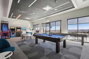 Playroom with billiards table and a high ceiling