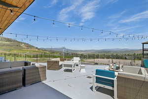 View of patio / terrace featuring outdoor seating and a mountain view
