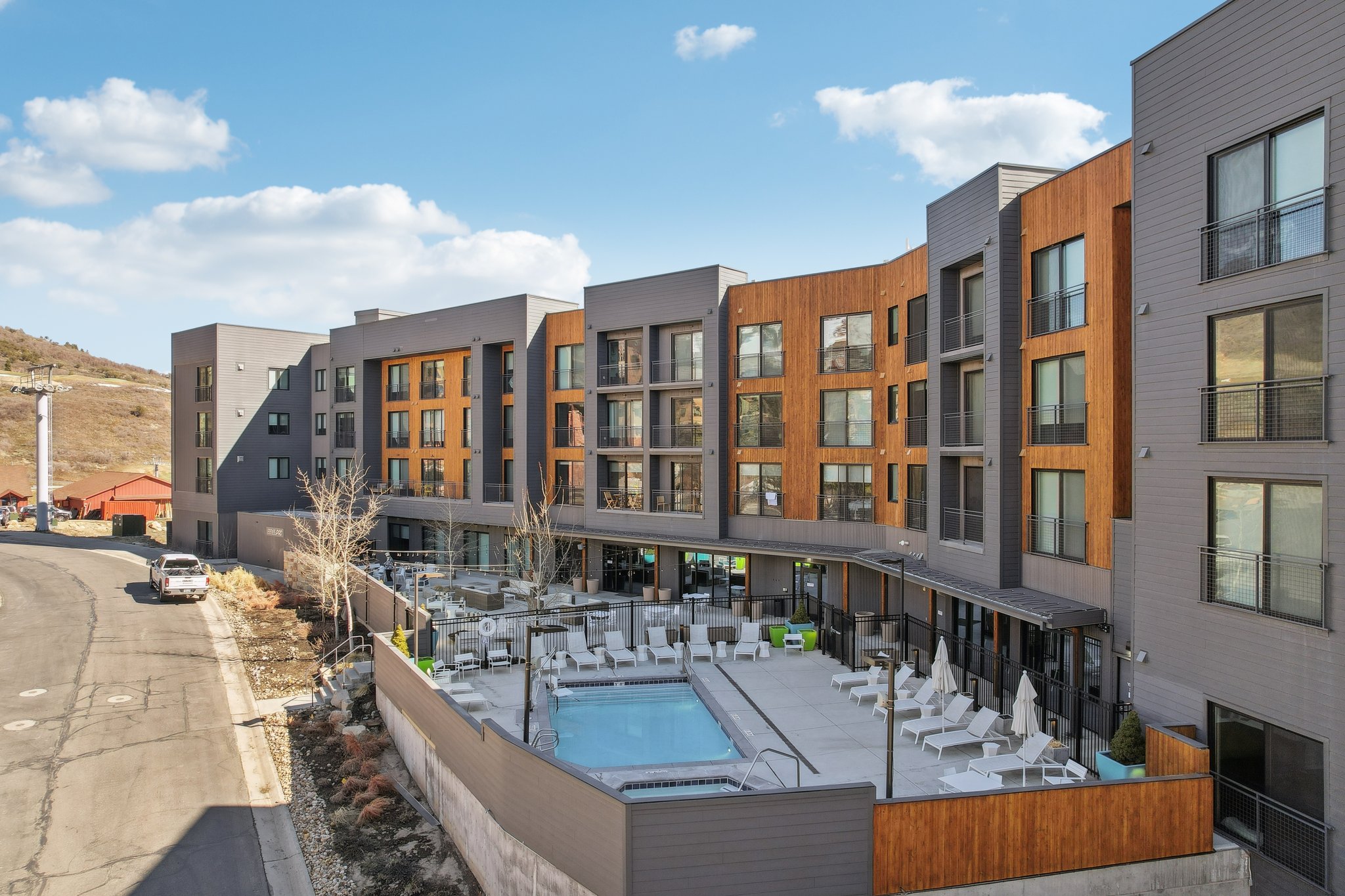 Community pool featuring a patio and a hot tub