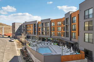 Community pool featuring a patio and a hot tub