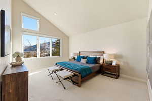 Bedroom with a mountain view, carpet floors, and vaulted ceiling