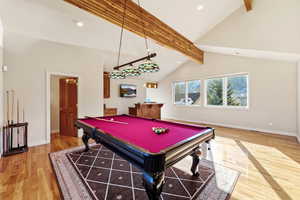 Rec room featuring billiards, recessed lighting, light wood-style floors, lofted ceiling, and shuffleboard