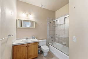Bathroom featuring enclosed tub / shower combo and vanity