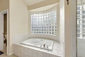 Bathroom with a whirlpool tub and plenty of natural light