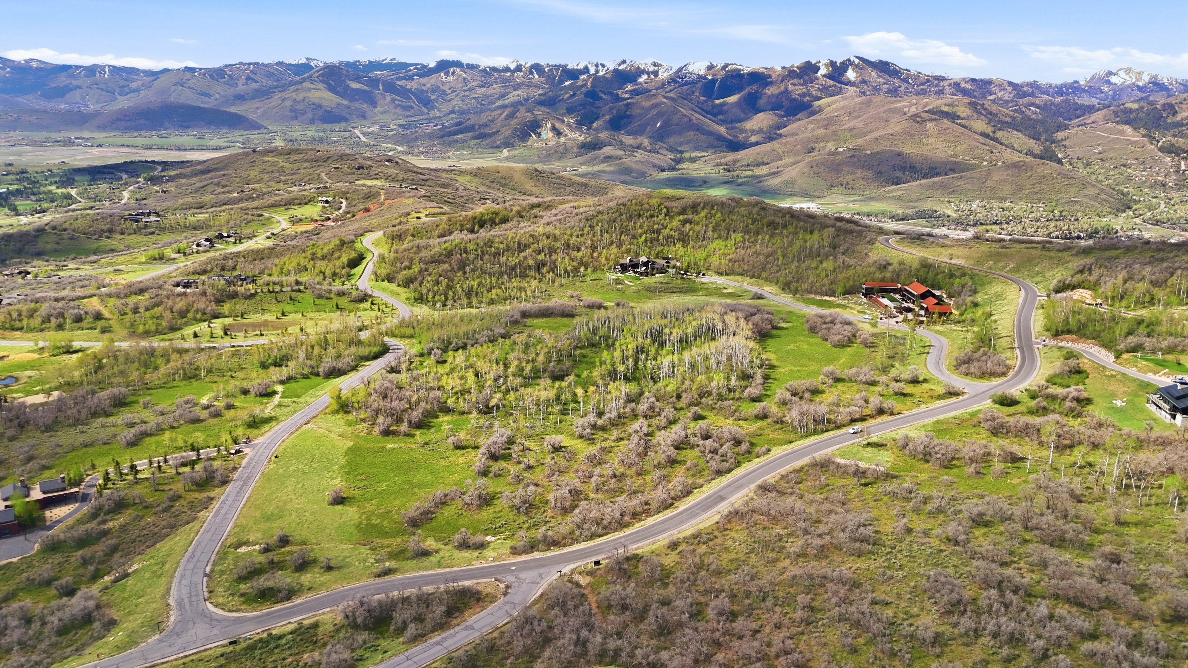 Expansive mountain landscape featuring varied topography with paved roadways