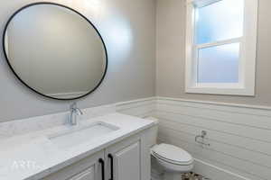 Bathroom with vanity and wainscoting