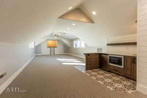 Bonus room with light colored carpet, ceiling fan, and recessed lighting