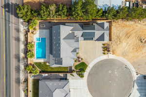Aerial view of property and surrounding area featuring a pool area