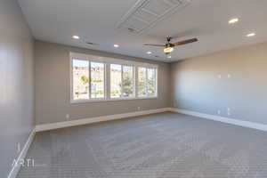 Empty room with cooling unit, a ceiling fan, carpet, and recessed lighting