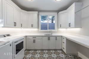 Laundry area featuring washer and dryer and a sink