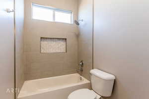 Full bath featuring toilet and shower / bathtub combination
