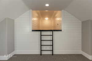 Additional living space with carpet and baseboards
