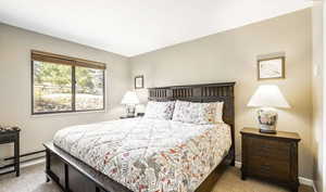 Carpeted bedroom featuring baseboards