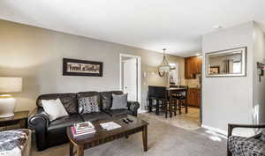 Living room featuring baseboards and light colored carpet