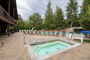 Community pool featuring a patio and a hot tub