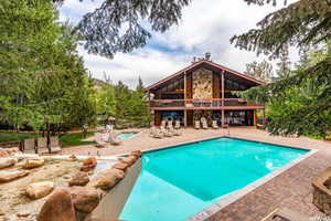 Community pool featuring a patio and a balcony