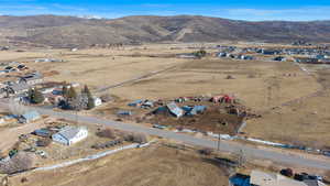 Aerial view of property and surrounding area with rural landscape and nearby suburban area