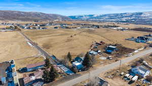 Overview of rural landscape with nearby suburban area and a mountain backdrop