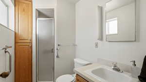 Full bath with a stall shower and vanity