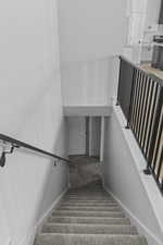 Stairs featuring carpet and baseboards