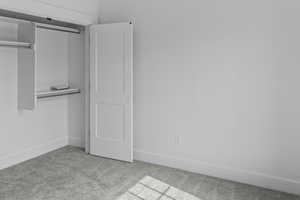 Unfurnished bedroom with a closet and carpet