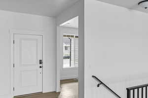 Entrance foyer featuring wood finished floors and baseboards