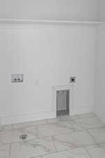 Laundry area featuring marble look tile flooring, washer hookup, and hookup for an electric dryer