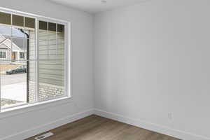 Empty room with baseboards and wood finished floors