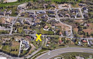 Aerial overview of property's location featuring nearby suburban area