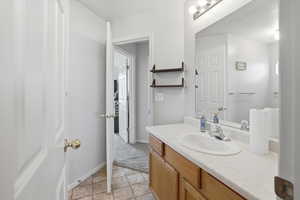 Bathroom with vanity and baseboards