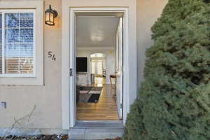 View of exterior entry featuring stucco siding