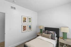 Bedroom featuring carpet and baseboards
