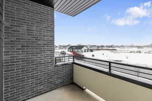 View of snow covered back of property