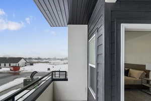 View of snow covered back of property