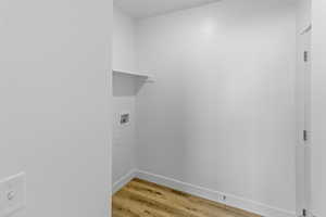 Laundry room with light wood-style flooring and washer hookup