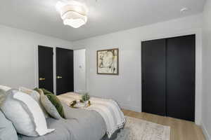 Bedroom with wood finished floors and baseboards