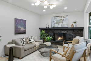 Living area featuring a stone fireplace and recessed lighting