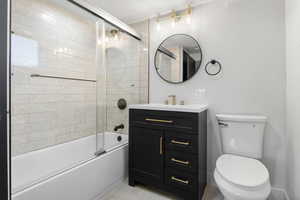 Full bathroom featuring vanity and enclosed tub / shower combo