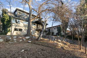 View of property exterior with brick siding and a balcony