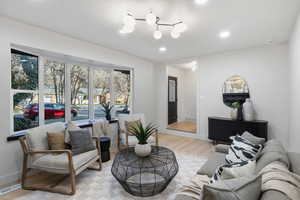 Living room with light wood-style floors and recessed lighting