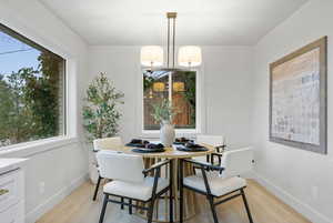 Dining room featuring light wood finished floors and suspended lighting