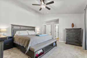 Bedroom with light carpet, lofted ceiling, and ceiling fan