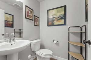 Bathroom featuring toilet and baseboards