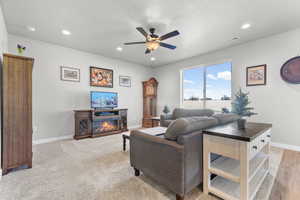 Living area featuring ceiling fan, recessed lighting.