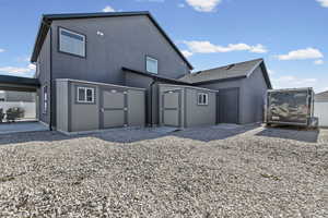 Rear view of house featuring a gate and a shingled roof