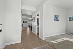 Corridor with light wood finished floors and baseboards