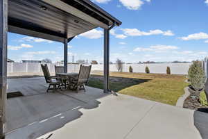 Fenced backyard with a patio area and outdoor dining area